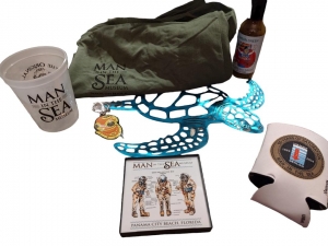Secondary image for the 1 year Family Membership to Man in the Sea Museum PCB. Includes 3 tshirts, Jalapeno sauce, keychain, metal sea turtle in a blue basket. Value $120 Auction Item